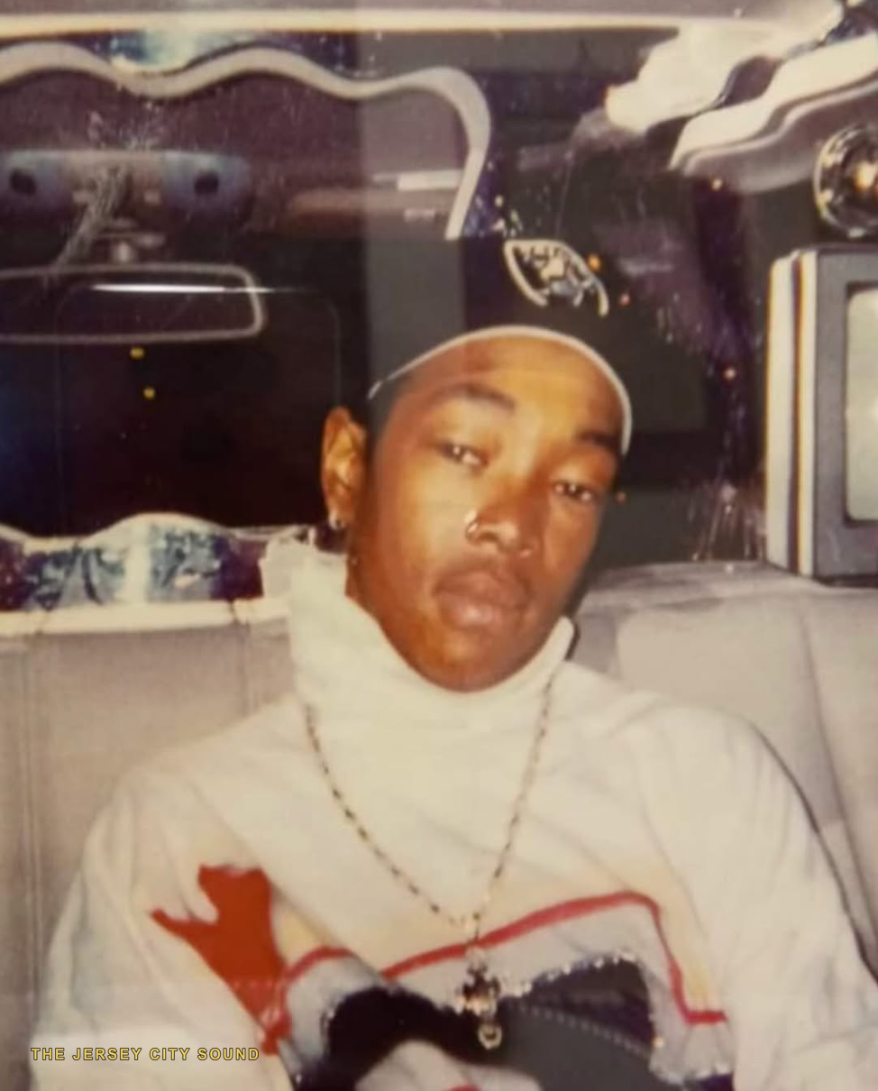 Green Bean seated in a customized car interior, memorial photo
