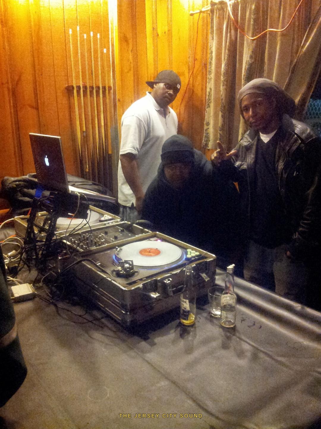 DJ Flash behind turntables with DJ Nyce and DJ Hazz B