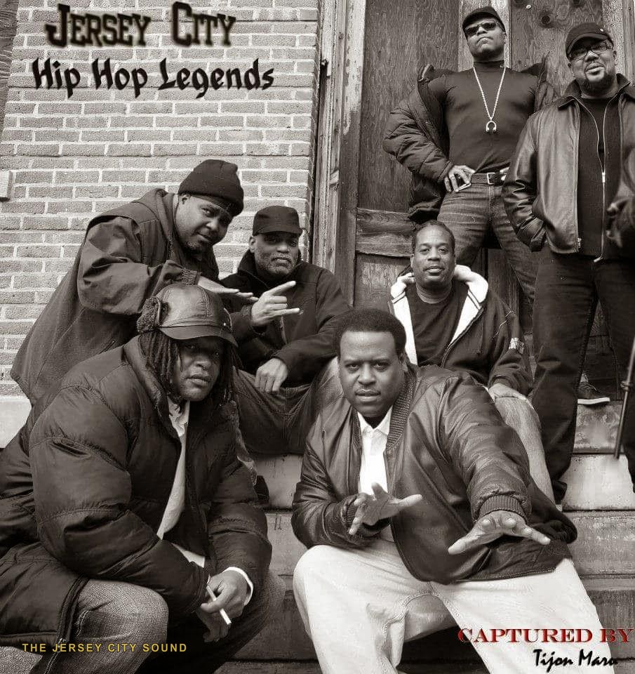 Jersey City Hip Hop Legends group portrait of seven pioneers on a stoop, captured by Tijon Maro