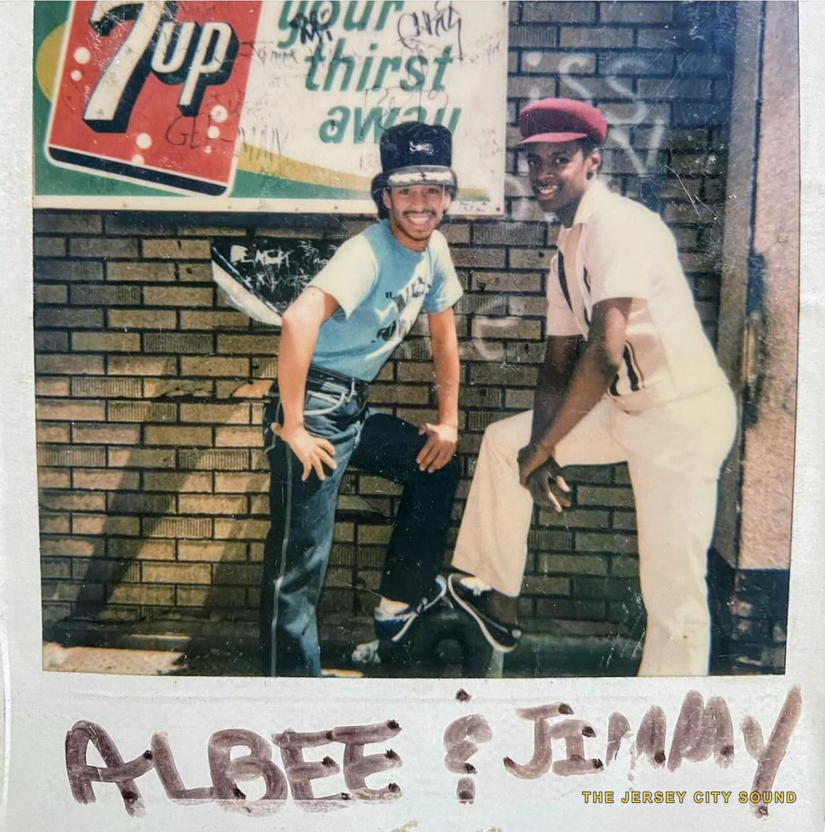 Polaroid of two young men posed under a 7up sign, hand captioned Albee and Jimmy