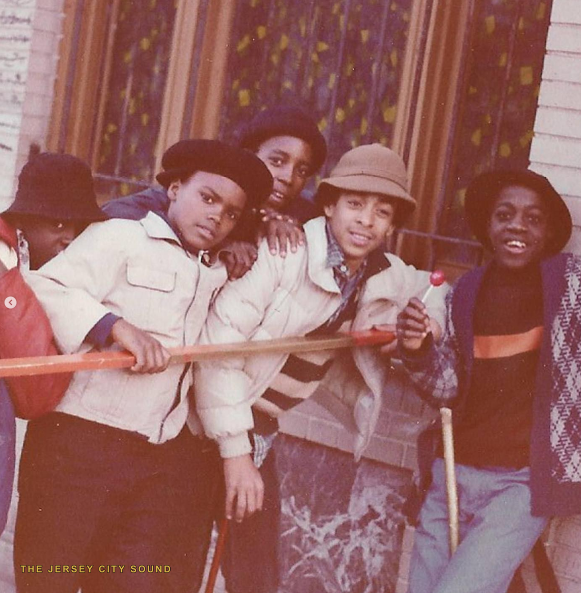 Five kids in hats posed on a stoop in the 1970s