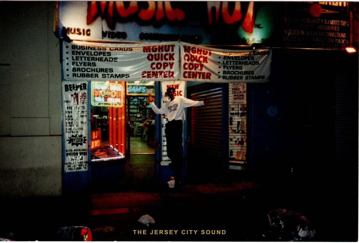 Mista Quietman posed at the doorway of the Music Hut, a music store advertising DJ mixed tapes